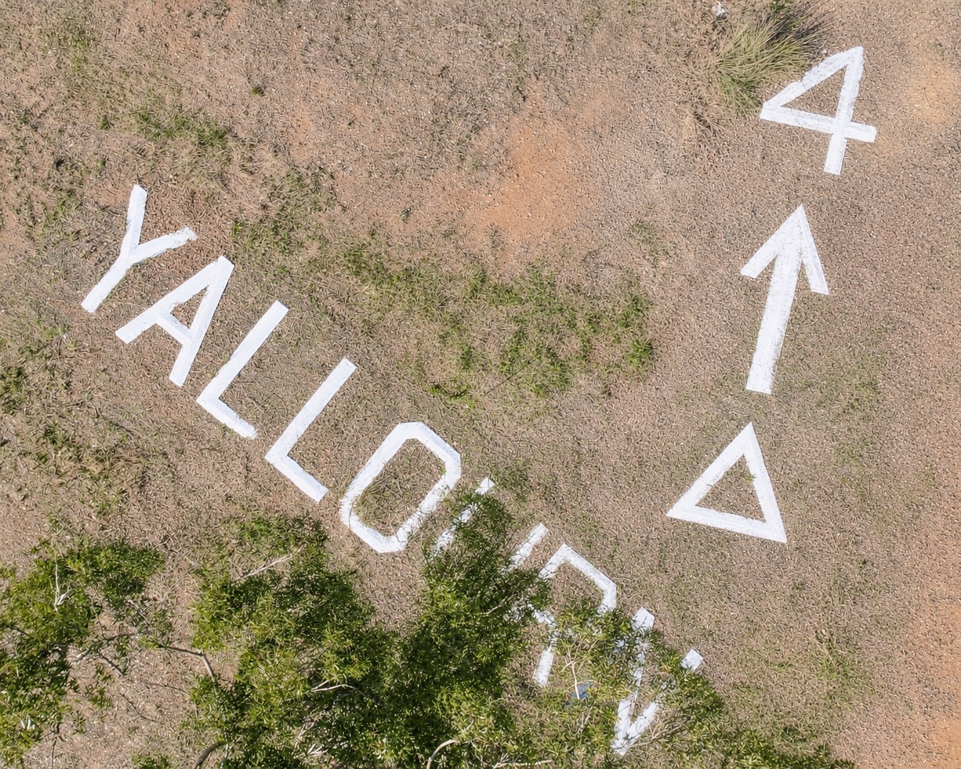 Aerial view of the Yallourn ground sign, including the word Yallourn, directional arrow, triangles and the number four.