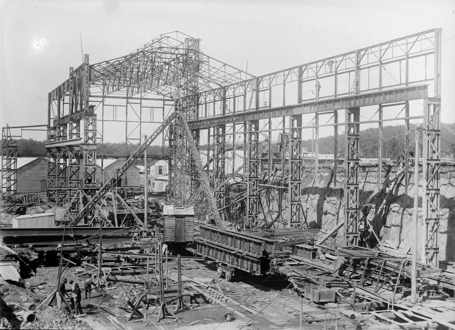 Historical construction scene showing workers and the steel frame of Yallourn’s A turbine house.
