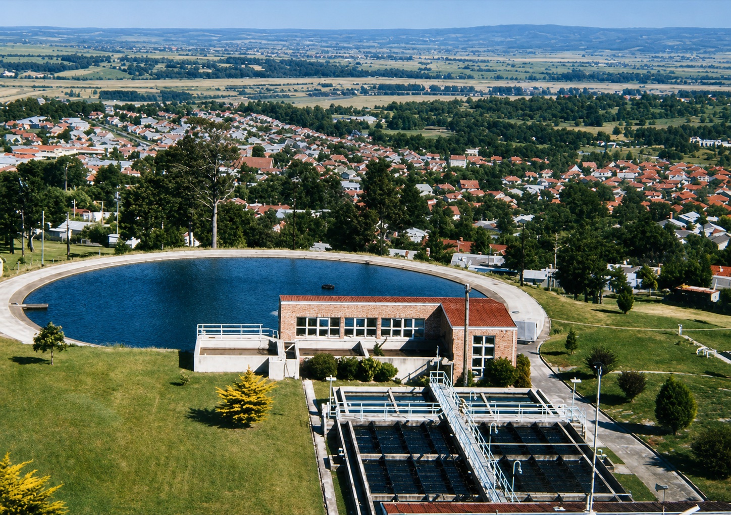View from the Yallourn reservoir across the treatment works towards the houses, trees and streets of Yallourn before the town was removed.