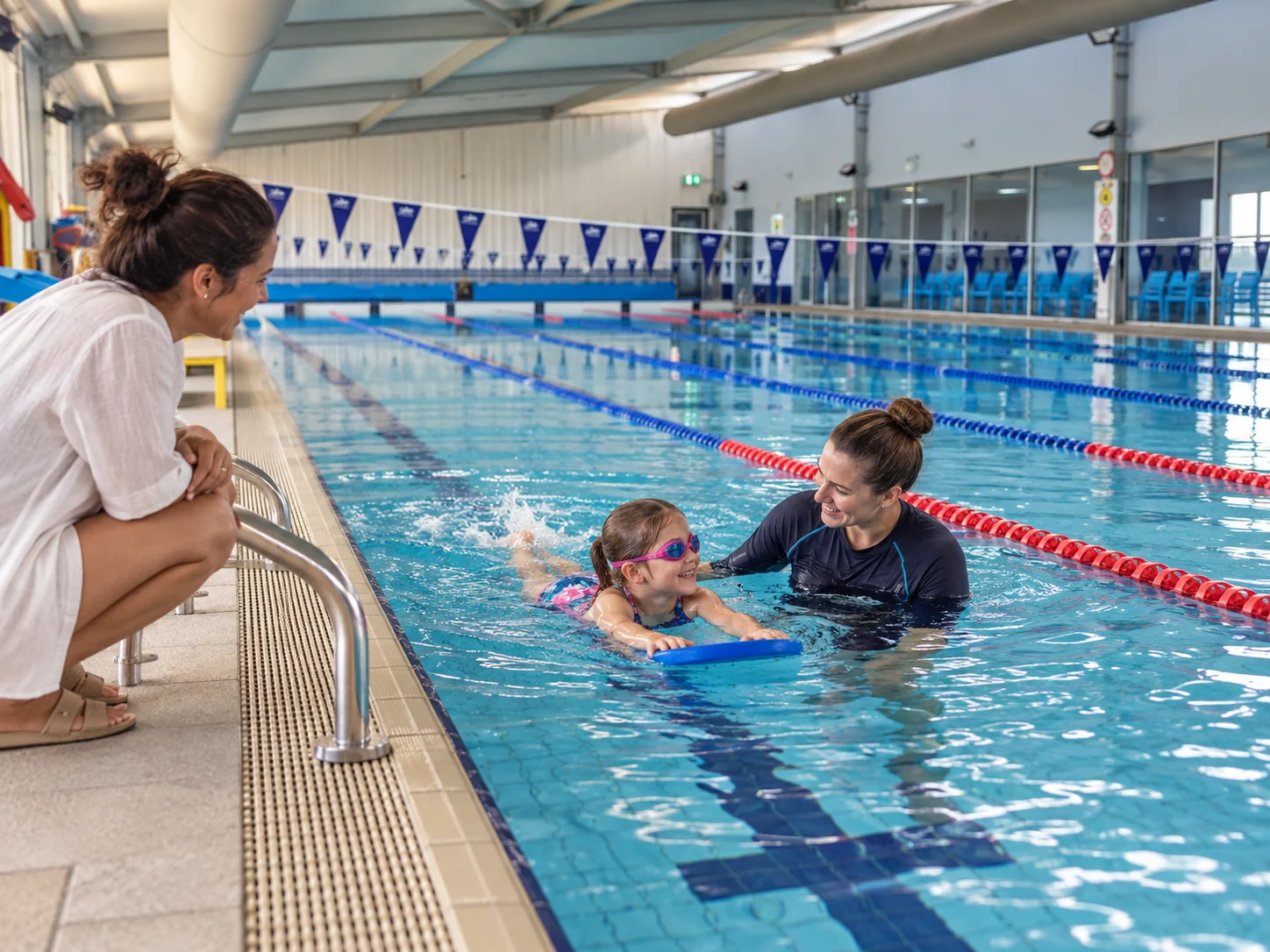 Interpretive scene of a swimming instructor helping a child build confidence while a parent watches