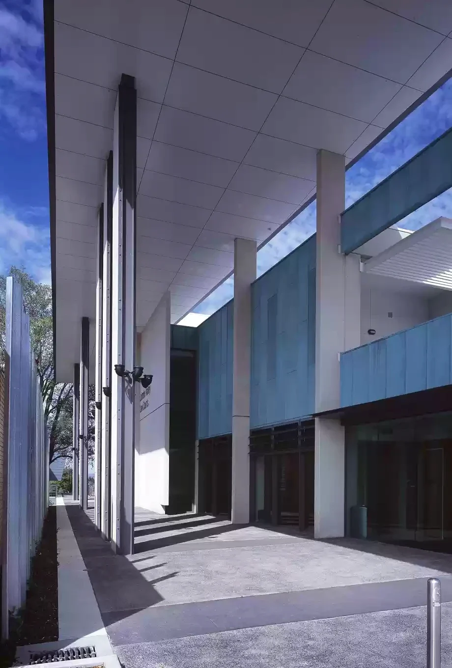 Tall columns and blue-green panels line a covered entrance at the Latrobe Valley Law Courts.